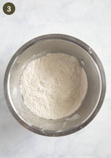 mixed flour and baking powder in a bowl for adding to cake batter.
