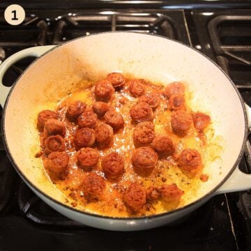 cooking sliced chorizo for making paella in a large pan.