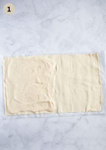 spreading one half of a puff pastry sheet with cream cheese and vanilla filling.