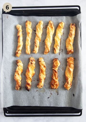 golden baked cream cheese and puff pastry twists on a baking sheet.