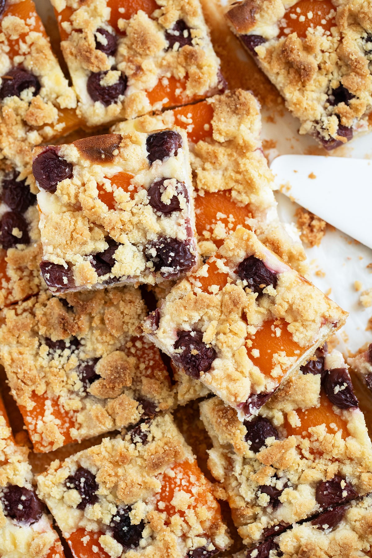 fruit cake with crumbles cut into smaller pieces.