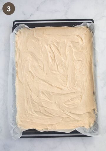 cake batter on a baking sheet lined with parchment paper.