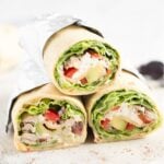 three shredded chicken wraps showing the filling.