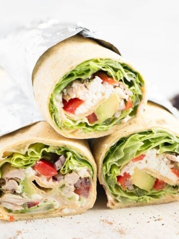 three shredded chicken wraps showing the filling.