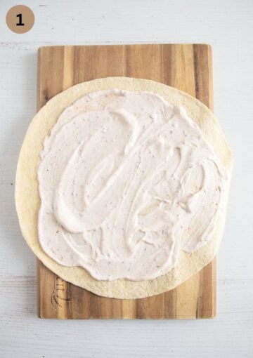 tortilla spread with sour cream to make shredded chciken wraps.