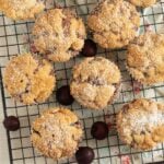 cherry streusel muffins sprinkled with confectioners's sugar and a few fresh cherries.