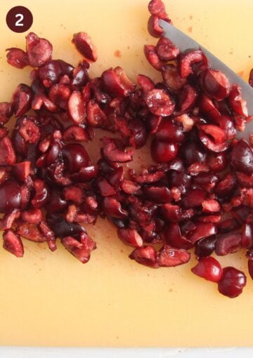 chopped fresh cherries on a chopping board.