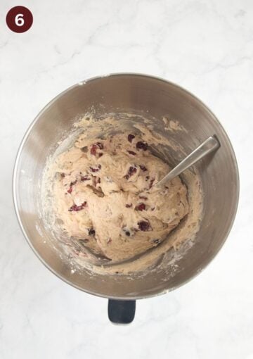 folding chopped fresh cherries into muffin batter with a spoon.