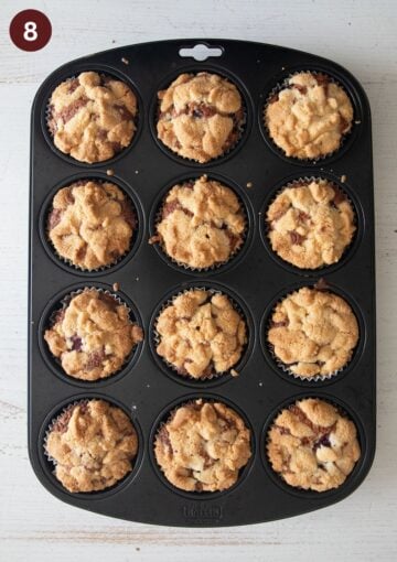baked cherry streusel muffins in a muffin tray.