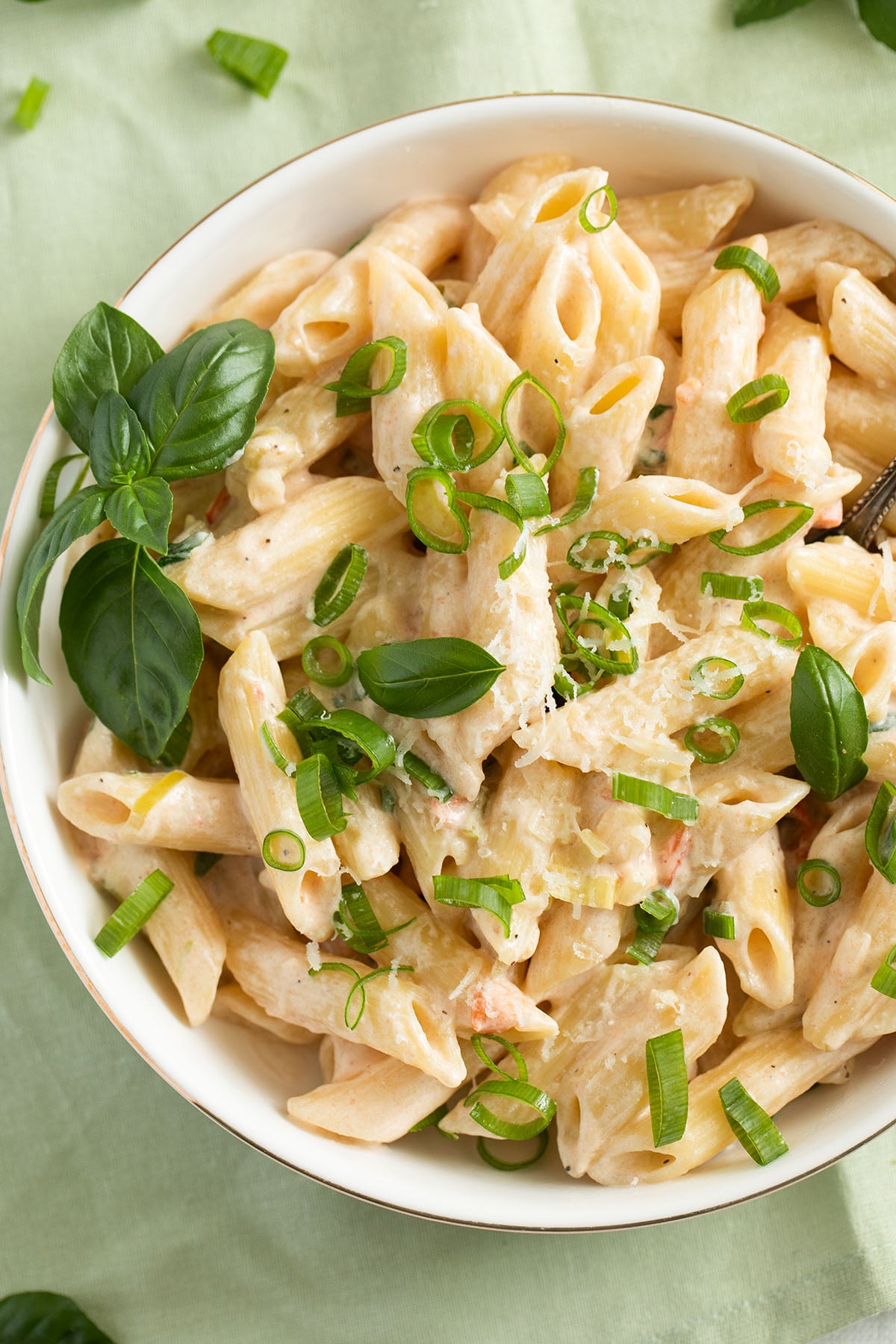scallion or green onion pasta with parmesan and basil in a bowl.