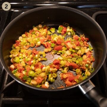sauteing chopped green onions, tomatoes, and garlic for making pasta sauce.