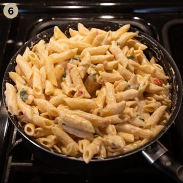 mixing penne with cream cheese and green onion sauce in a large saucepan.