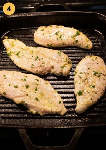 marinated chicken breasts cooking in a grill pan.