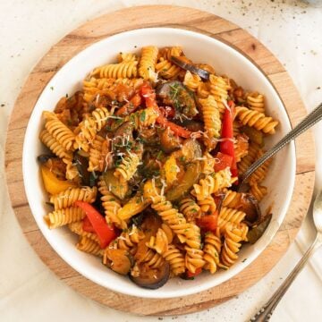 ratatouille pasta with eggplants, zucchini and peppers in a bowl.