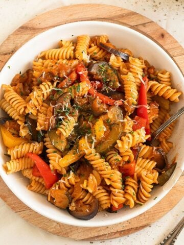 ratatouille pasta with eggplants, zucchini and peppers in a bowl.