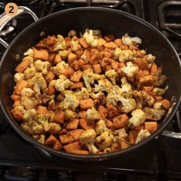 sauteing sweet potatoes, cauliflower and onions in a large saute pan to make curry.