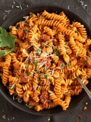 chorizo pasta sprinkled with parmesan and garnished with parsley.