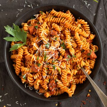 chorizo pasta sprinkled with parmesan and garnished with parsley.