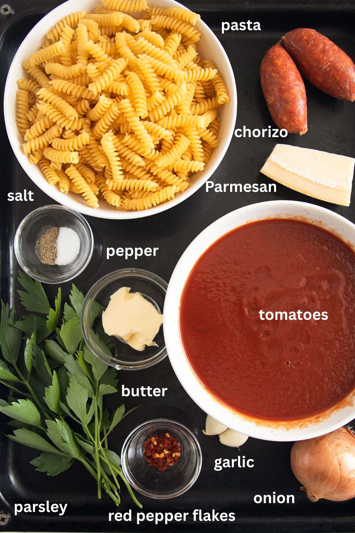 labeled ingredients for making pasta with chorizo, passata, parsley, and parmesan.