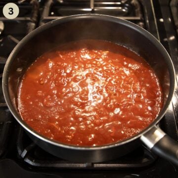 simmering tomato sauce for chorizo pasta in a saucepan.