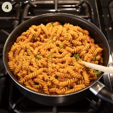 stirring parsley into chorizo pasta in a skillet on the stovetop.