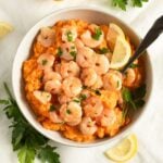shrimp and sweet potato mash served with lemon wedges in a bowl.