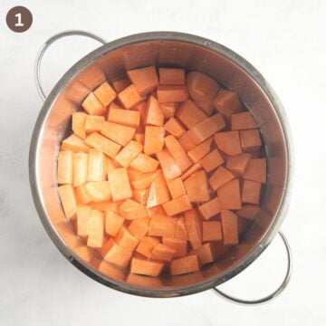 chopped sweet potatoes in a pot with water before cooking.