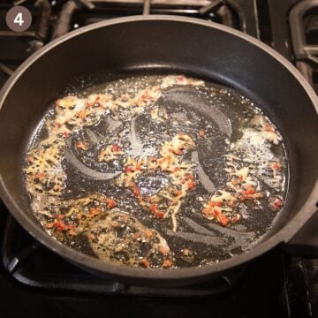 sauteing chopped garlic, chili and lemon zest in a skillet.