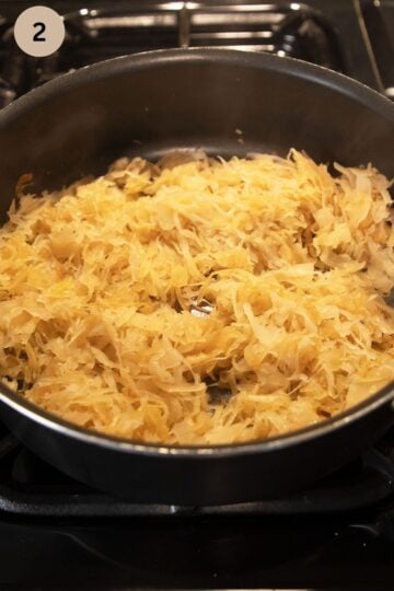 sauerkraut cooking in a skillet on the stove.