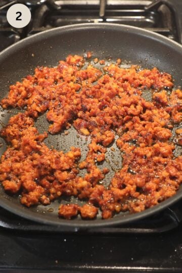 cooking chorizo for quesadillas in a pan.