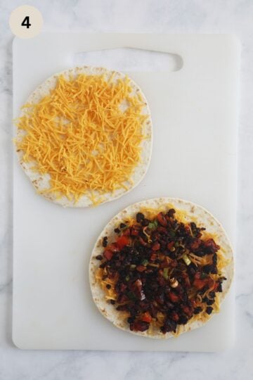 assembling quesadillas with cheddar and chorizo filling.